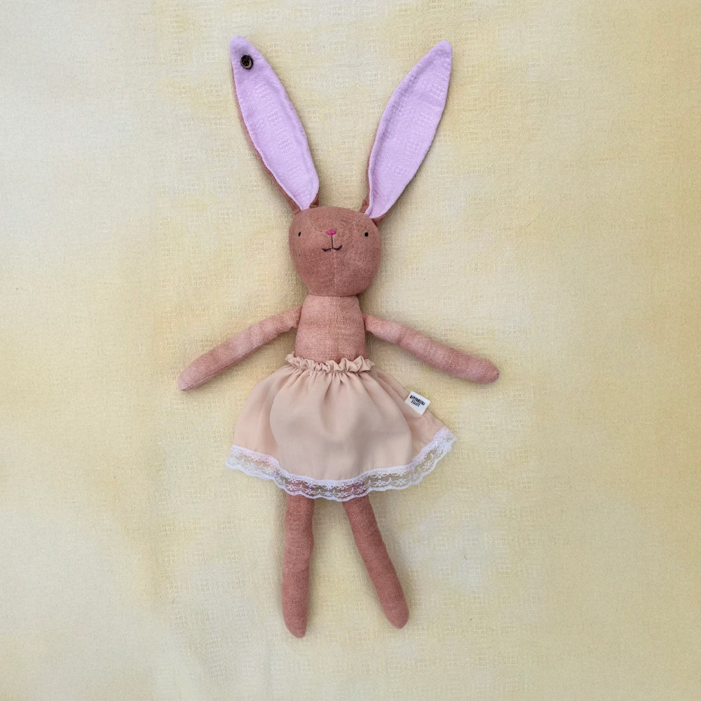 A Nogwaja bunny with pink ears and a ruffled skirt, made from upcycled hospital blankets